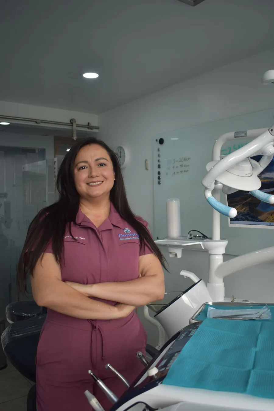 Photograph of a dentist standing in a modern operatory